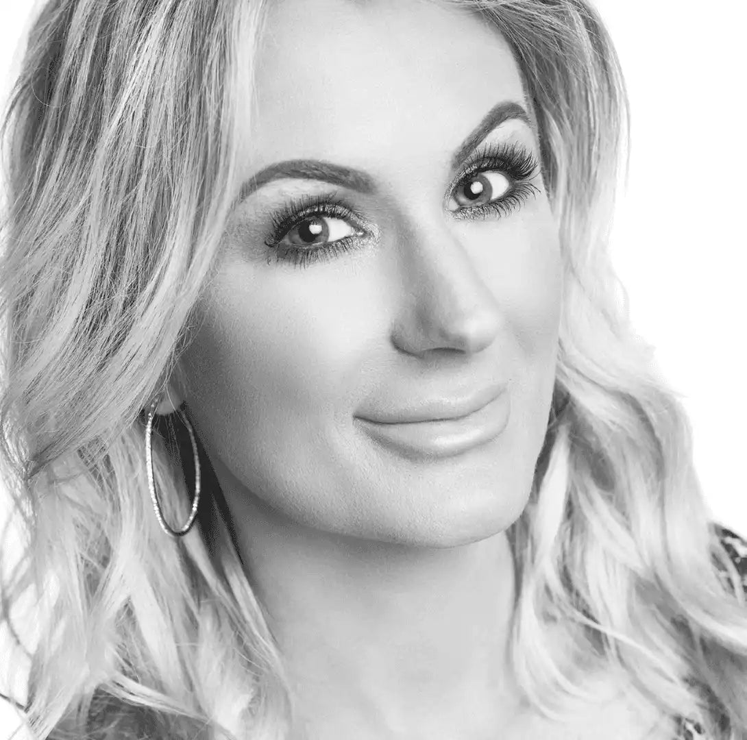 Woman with long, voluminous lashes and defined brows, showcasing natural beauty