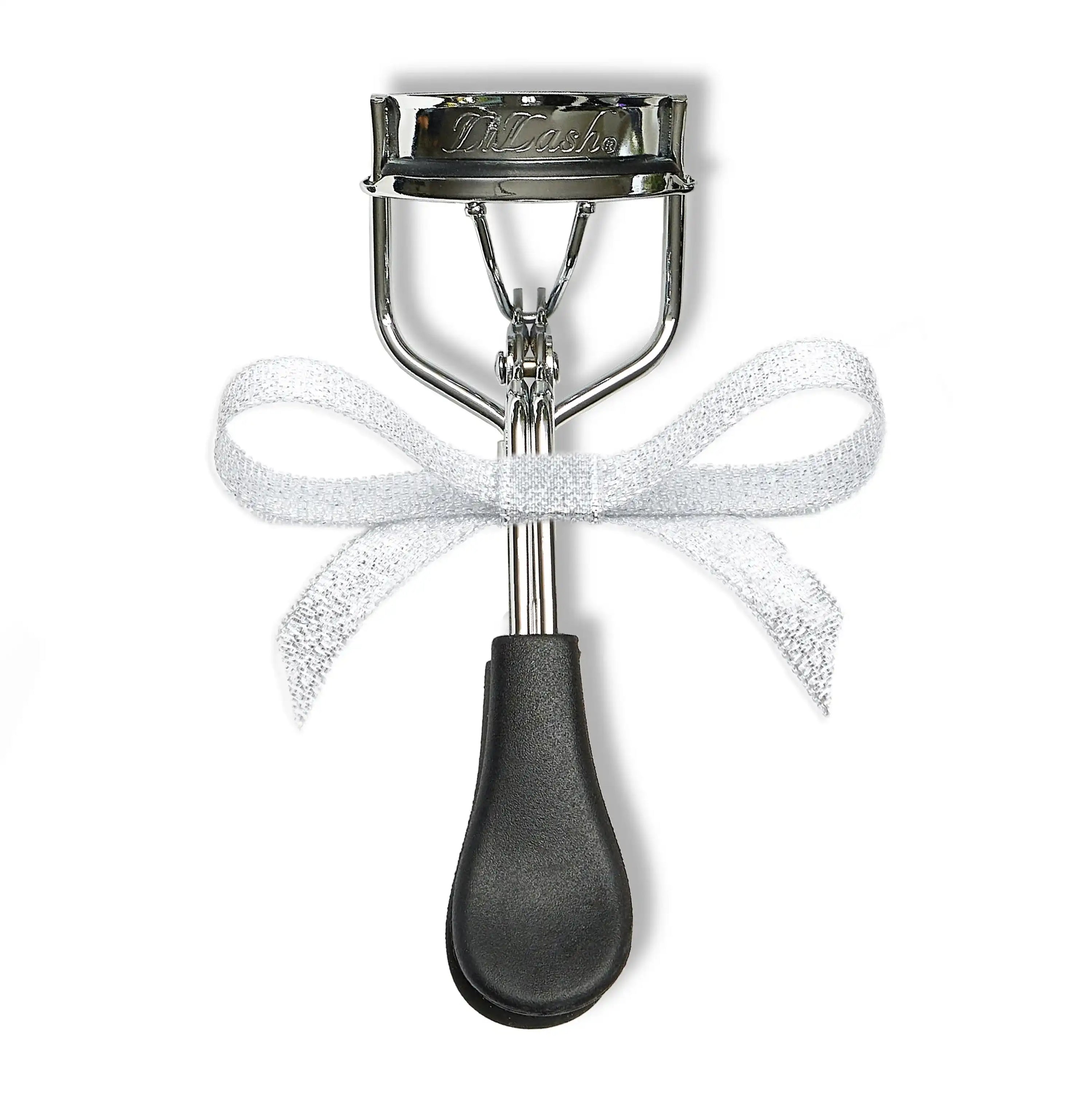 Silver eyelash curler with black handle and white ribbon bow, for defined lashes and brows