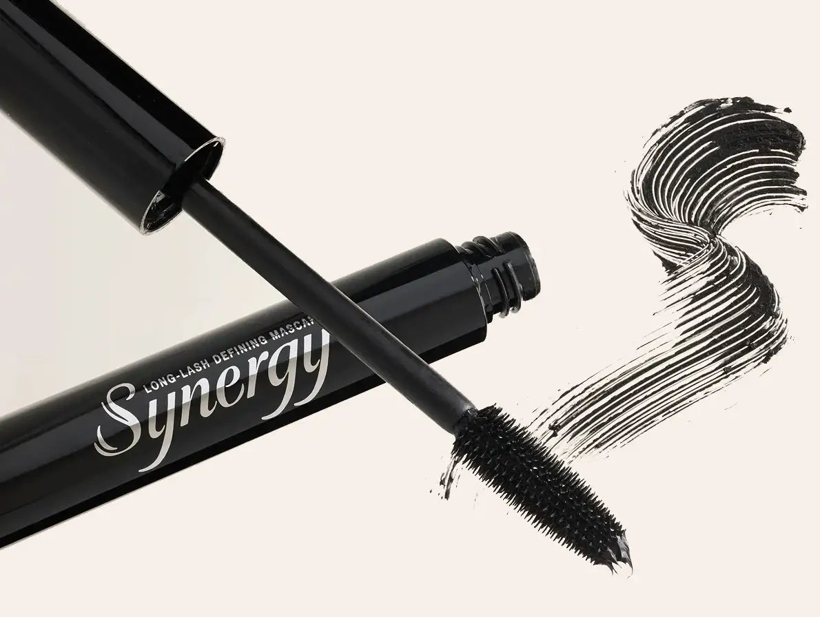 Synergy long-lash defining mascara wand and tube with a black mascara swatch on a white background