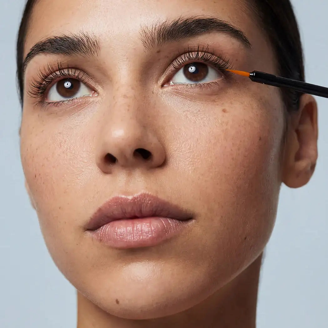 Applying lash serum for longer, fuller lashes with precise brush applicator