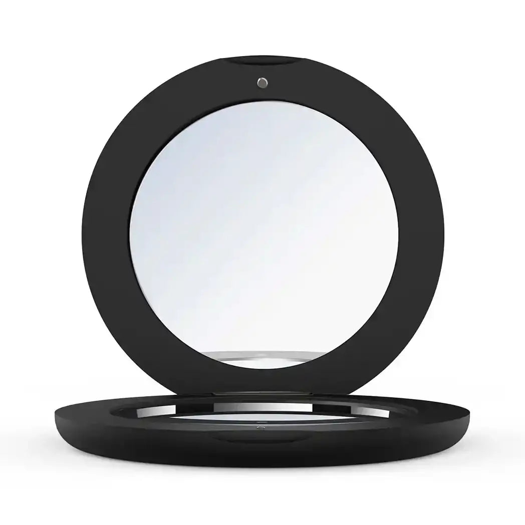 Sleek black compact mirror with round design for beauty and makeup application
