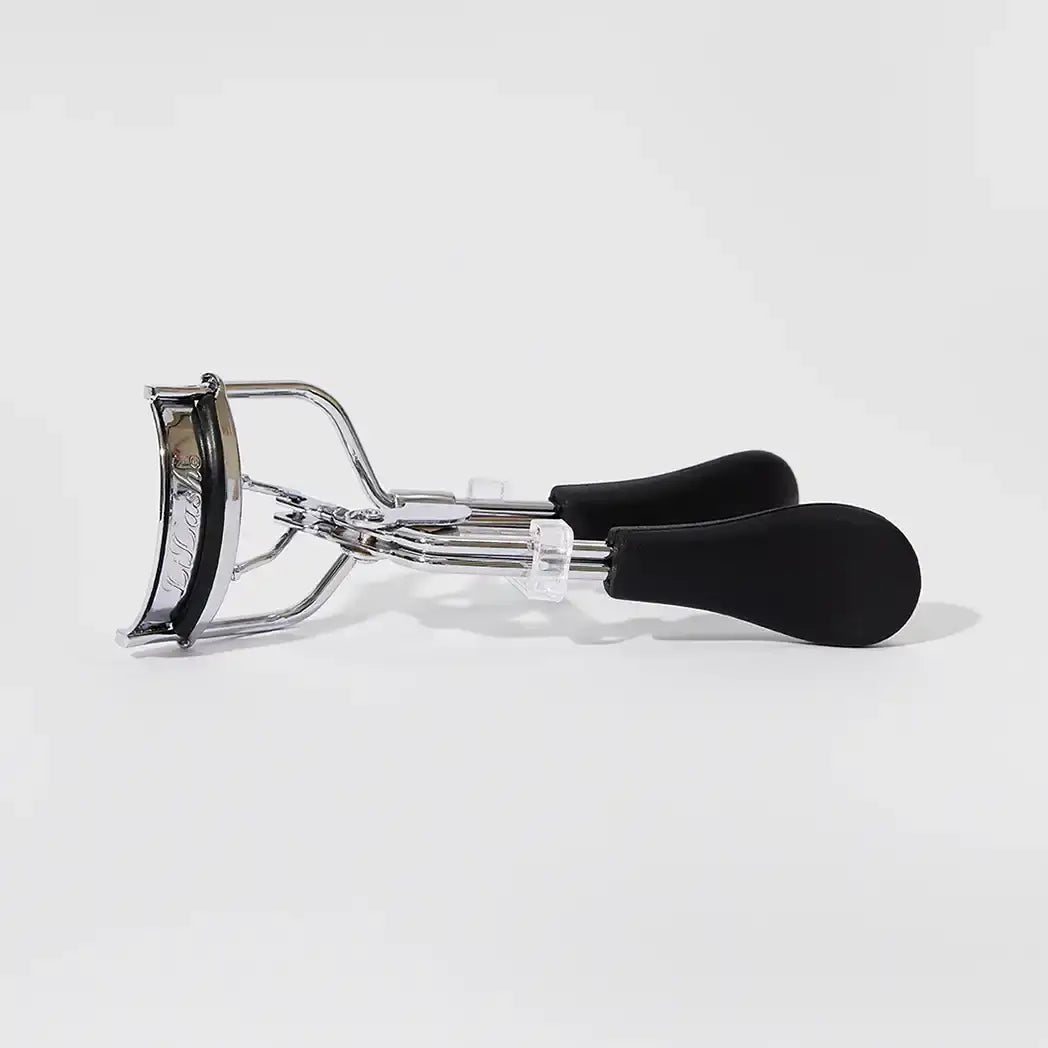Chrome eyelash curler with black handles for defined, lifted lashes