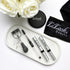 Eyelash and eyebrow serums with curler and spoolie on marble tray, white roses, black LiLash Beauty accessories