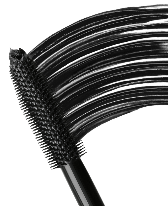 Close-up of a black mascara wand showing the bristle brush and coated lashes on a clean white background.
